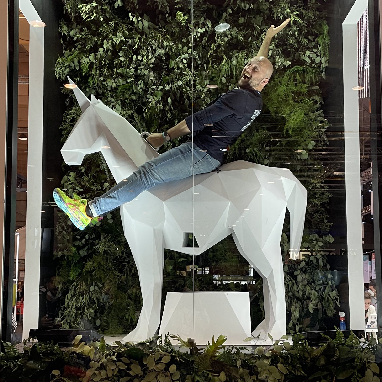 Dimitry riding a white horse sculpture at the EDP innovation stand