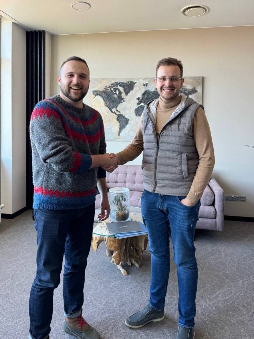 Dimitry shaking hands with an industry partner