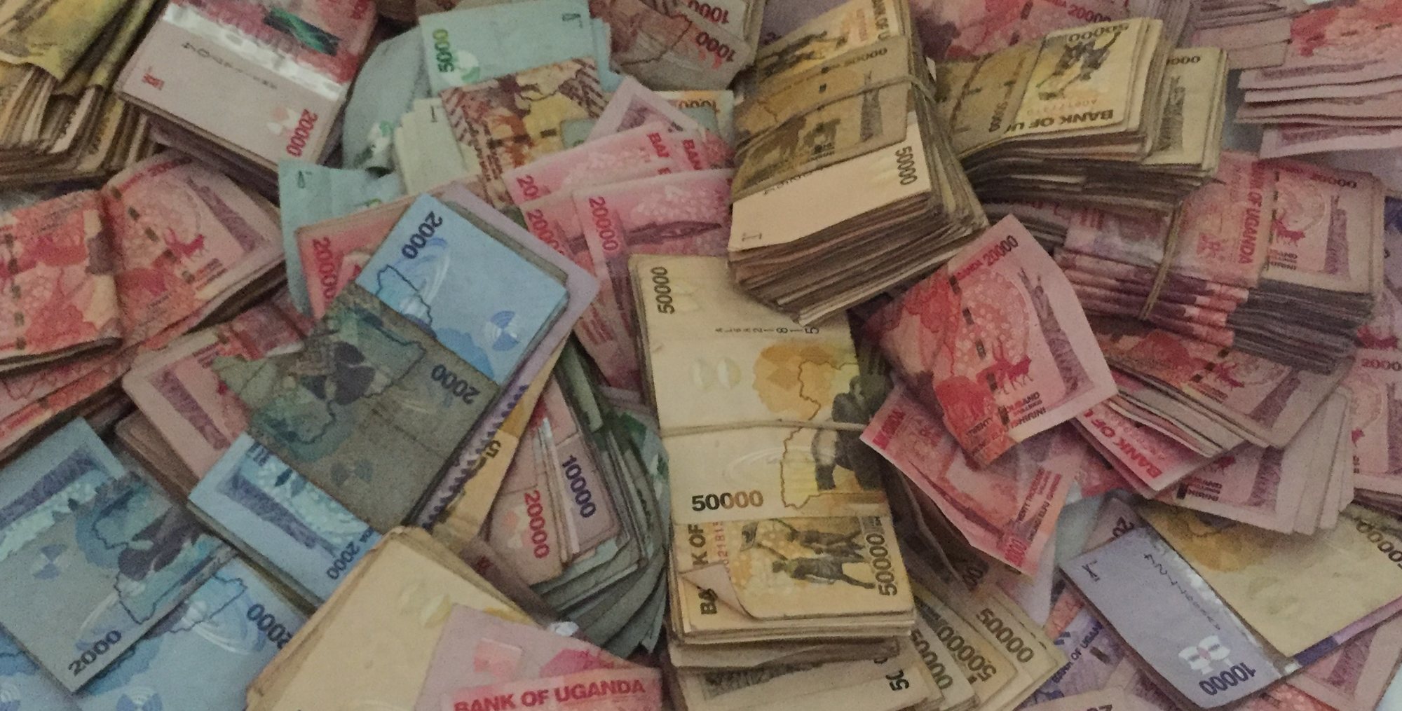 A pile of Ugandan shilling banknotes