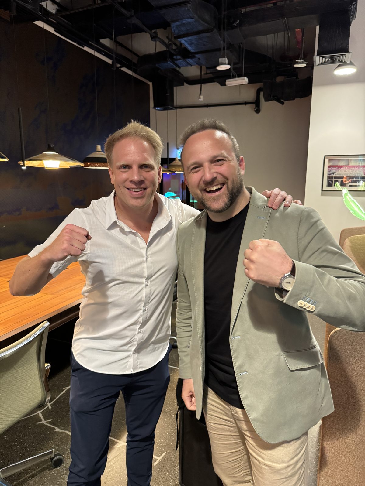 Dimitry and a fellow founder raising their fists